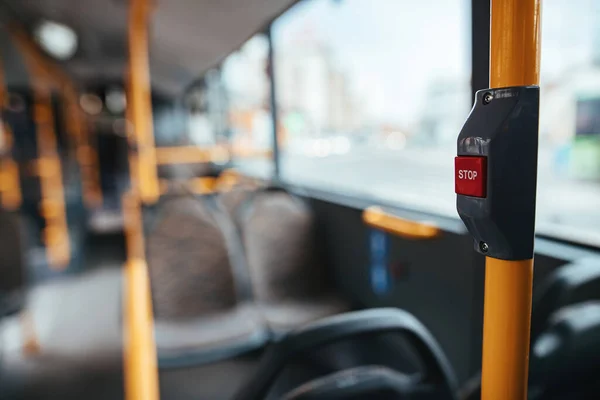 Close-up of handle in empty public bus during COVID-19 pandemic.