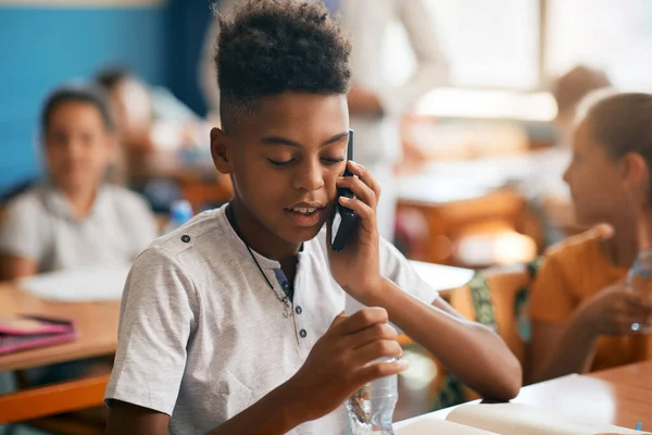 African American Elementary Student Making Phone Call Cell Phone While — 스톡 사진