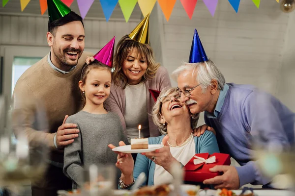 Happy Extended Family Celebrating Senior Woman Birthday Surprising Her Cake — стоковое фото