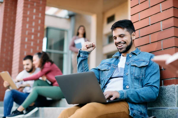Young Male Student Using Laptop Celebrating Getting Good Grade Exam — Fotografia de Stock