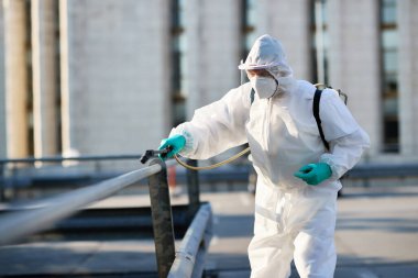 Disinfectant worker cleaning city streets during COVID-19 pandemic. 