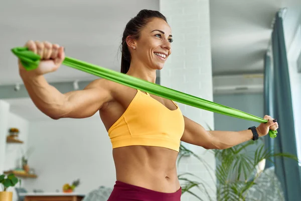 Low Angle View Young Muscular Build Woman Exercising Resistance Band — Foto de Stock