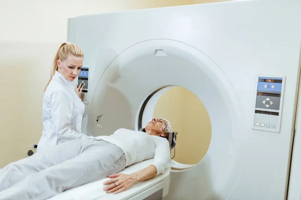 Female Medical Technician Mature Patient Scan Procedure Examination Room Hospital — Stockfoto