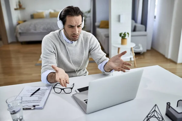 Young Displeased Businessman Having Video Call Laptop While Working Home — Stockfoto