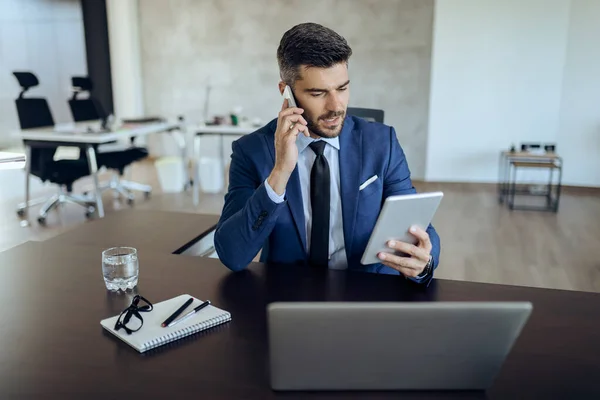 Young Businessman Working Digital Tablet While Talking Mobile Phone Office — Stock Fotó