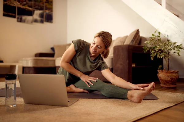 Happy Sportswoman Using Laptop While Stretching Floor Home —  Fotos de Stock