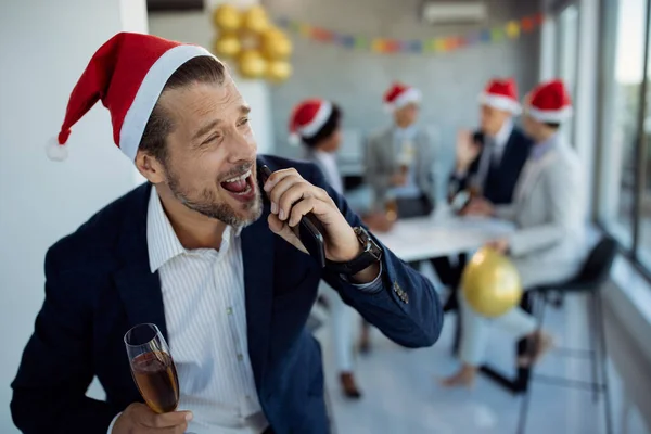 Drunk Businessman Holding Smart Phone Singing While Having Glass Champagne — ストック写真