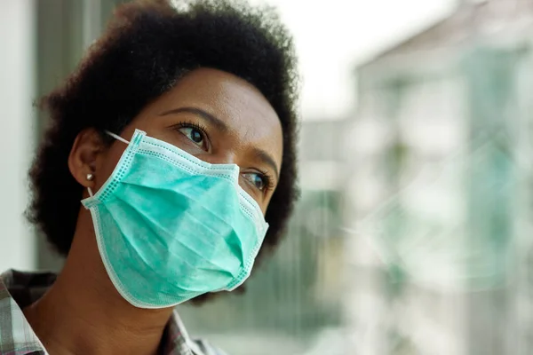 Distraught Black Woman Face Mask Thinking While Looking Window Home — Foto Stock
