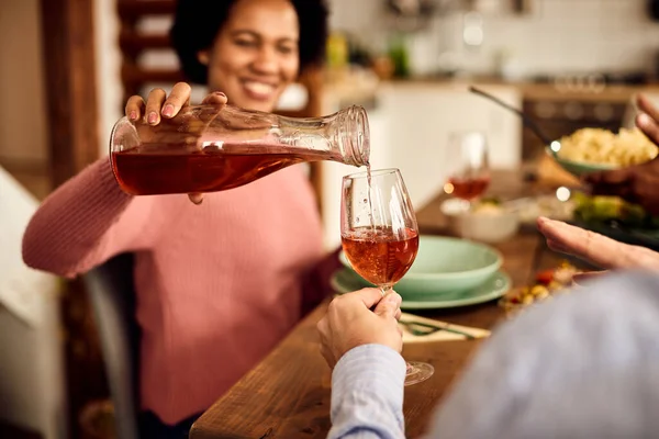 Close Black Woman Serving Wine While Having Dinner Her Friends — Foto de Stock