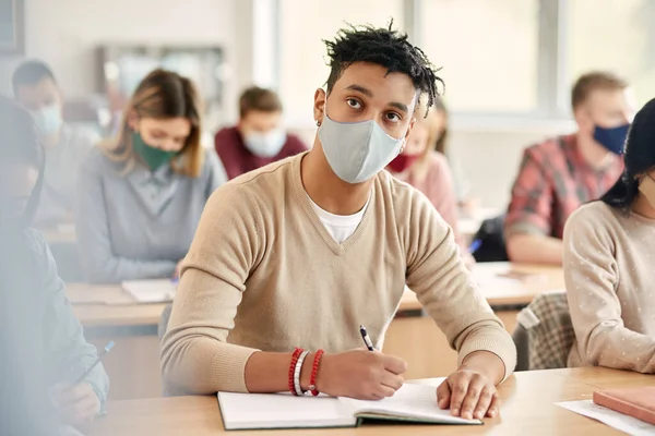 Young African American Student Writing Notebook While Attending University Classes — Foto Stock