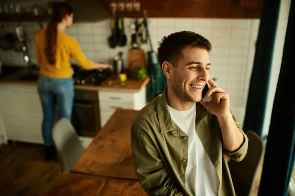 Happy Man Using Mobile Phone Communicating Someone While His Wife — Stockfoto