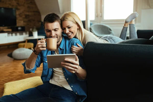 Young Happy Couple Using Digital Tablet While Enjoying Home — Foto de Stock