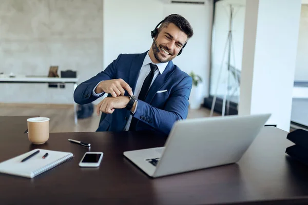 Happy Businessman Pointing His Wristwatch While Having Video Call Laptop — Stock Fotó