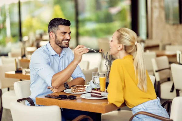 Happy Man Feeding His Girlfriend Cake While Having Dessert Cafe — стоковое фото
