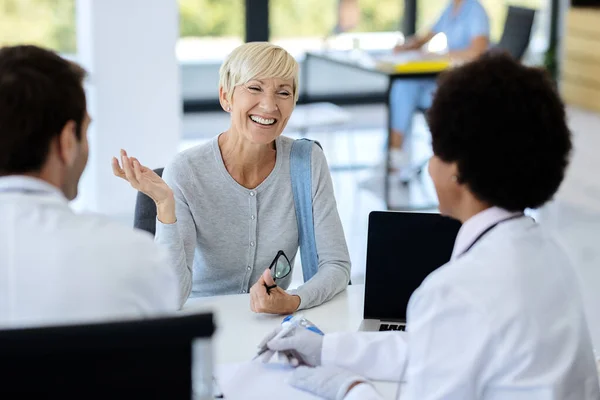 Happy Mature Woman Communicating Doctor Medical Appointment Clinic — Stockfoto