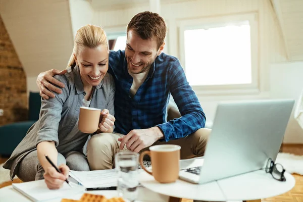 Young Happy Couple Working Home Budget While Drinking Coffee Living — Zdjęcie stockowe