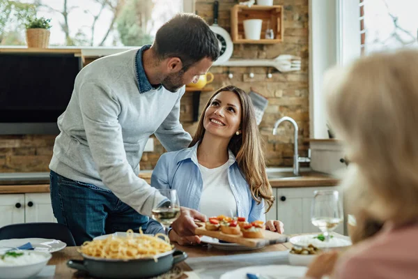 Happy Woman Talking Her Husband Who Serving Food While Having — Stockfoto