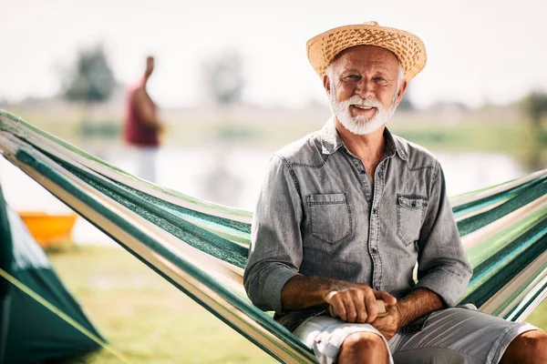 Happy Senior Man Enjoying Camping Day While Relaxing Hammock Looking — ストック写真