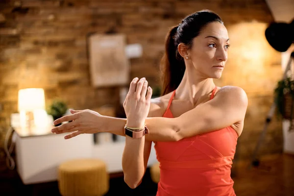 Athletic Woman Working Out Home Stretching Her Arm While Warming — Foto de Stock