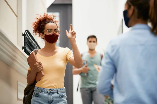 Happy Female Student Greeting Her Friend Wearing Protective Face Mask — Foto Stock