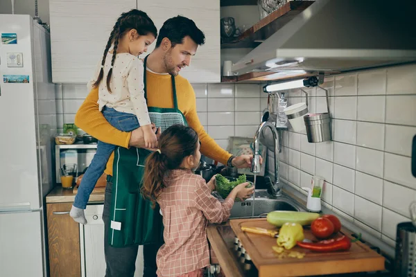 Mid Adult Father His Small Daughters Washing Vegetables While Coking — Fotografia de Stock