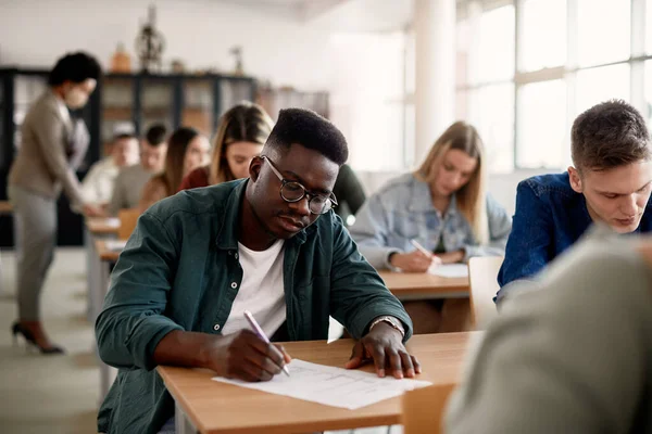 Black Male Student His Classmates Writing Exam University — Fotografia de Stock