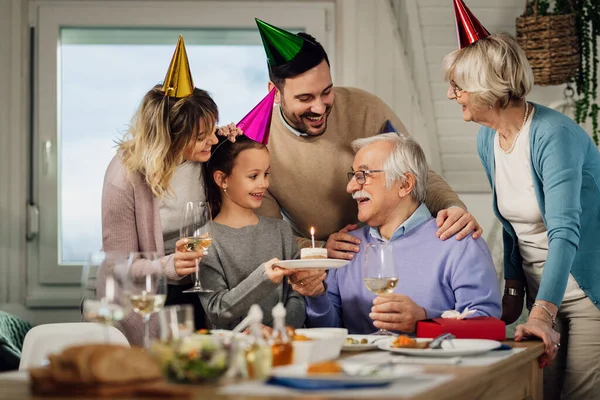 Happy Extended Family Having Fun While Surprising Senior Man Cake — стоковое фото