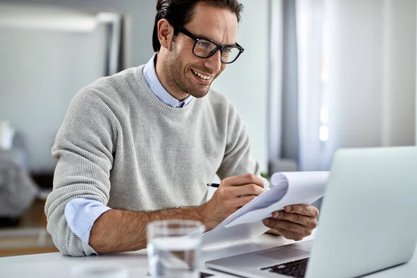 Young Happy Businessman Writing Reports While Working Computer Home — Stockfoto