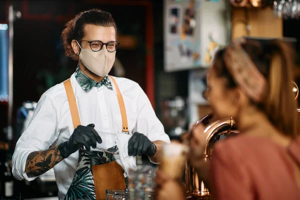 Happy Bartender Wearing Protective Face Mask While Cleaning Drinking Glasses — ストック写真