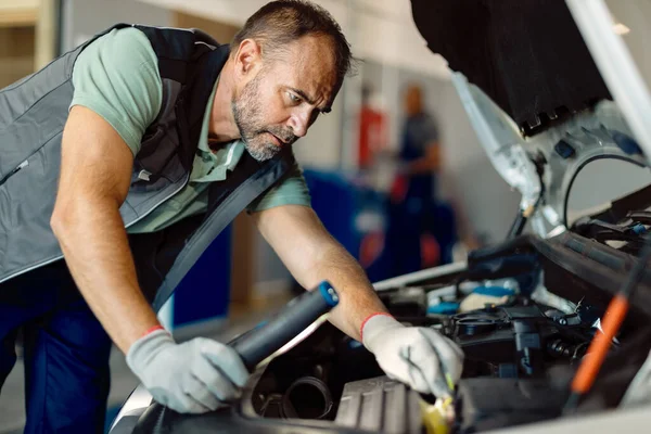 Mid Adult Auto Repairman Examining Car Engine Workshop —  Fotos de Stock