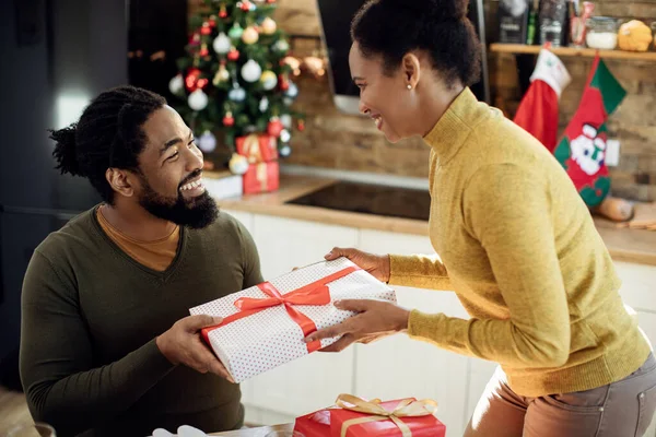 Happy African American Couple Giving Each Other Present Christmas Day — ストック写真