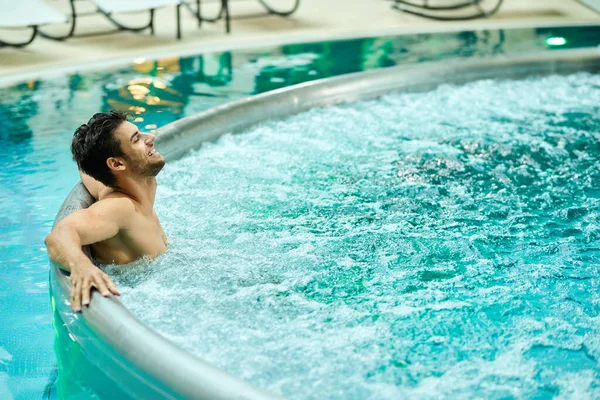 Young Relaxed Man Enjoying Hot Tub While Spending Day Wellness — Stockfoto