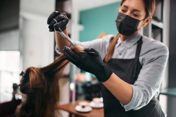 Close-up of woman having a haircut at hairdresser\'s during coronavirus pandemic.