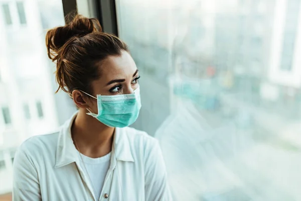 Young Distraught Woman Face Mask Standing Window Looking — 스톡 사진