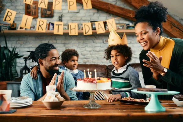 African American Little Girl Wearing Crown Blowing Candles Cake While — Foto de Stock