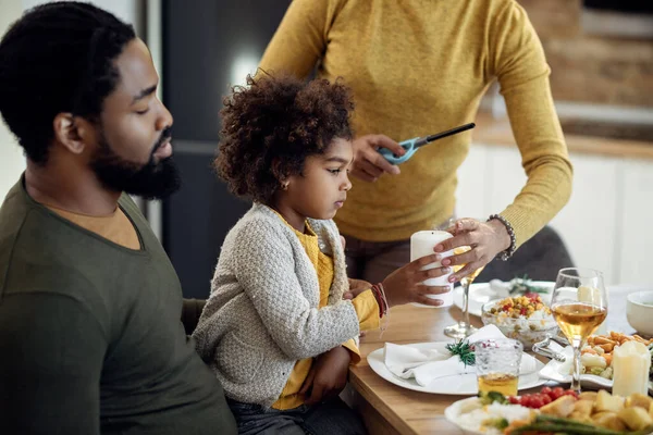 Black Little Girl Holding Candle While Having Family Lunch Dining — Foto de Stock