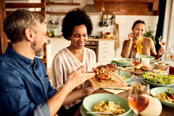 Smiling Black Woman Tasting Food While Having Dinner Friends Dining — Foto de Stock