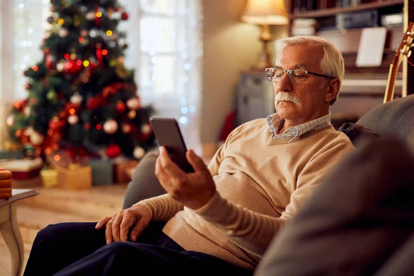 Mature Man Using Smart Phone While Relaxing Sofa Christmas Day — Photo