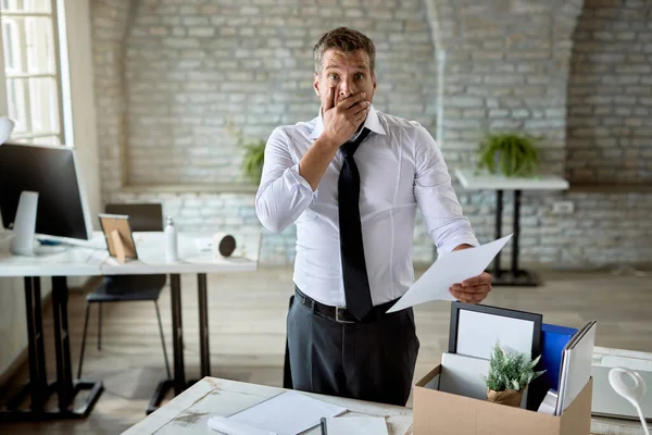 Shocked Businessman Standing Office Reading Notice Getting Fired His Job — Stockfoto