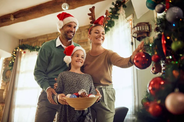 Low Angle View Happy Parents Daughter Enjoying Decorating Christmas Tree — ストック写真