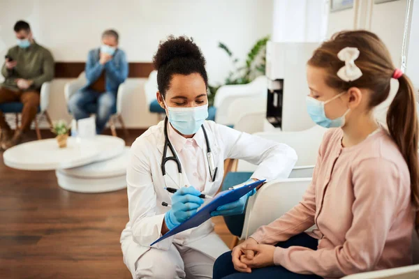 African American Dentist Writing Little Girl Data While Talking Her — 스톡 사진