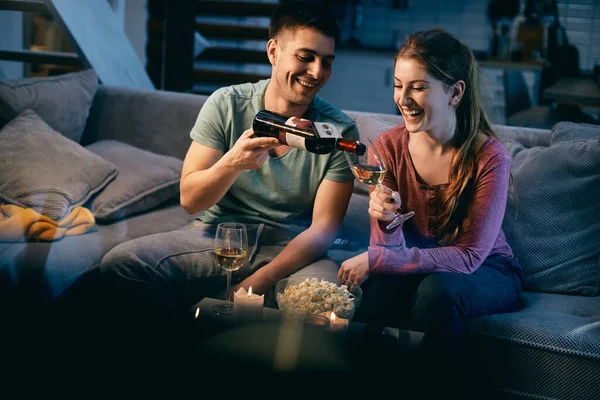 Happy Man Pouring Wine Girlfriend Glass While Relaxing Night Home — Stockfoto
