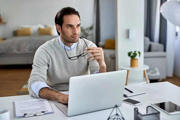 Young Businessman Thinking Something While Working Computer Home — Stockfoto