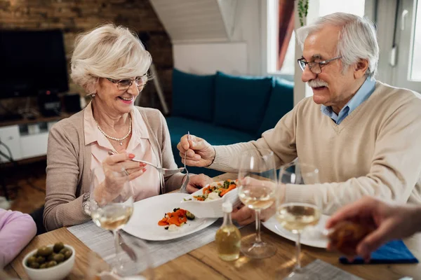 Happy Senior Man Serving Salad His Wife While Having Lunch — Foto de Stock