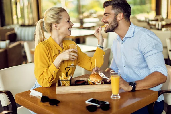 Happy Couple Having Fun Lunch Time Restaurant Woman Feeding Man — 스톡 사진