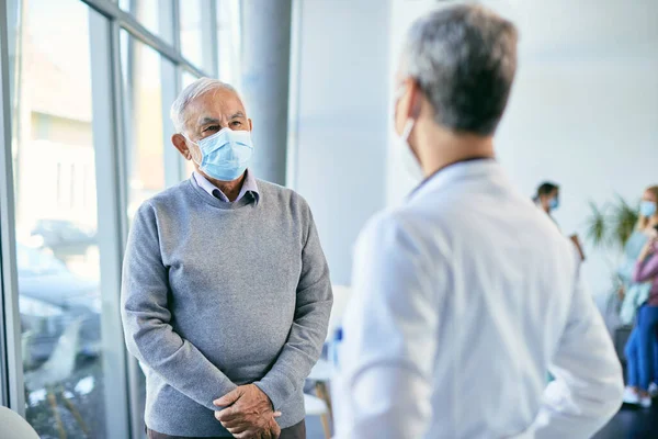 Senior Man Face Mask Standing Waiting Room Medical Clinic Talking — 스톡 사진