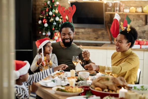 Joyful African American Family Using Sparklers While Having Lunch Celebrating — ストック写真