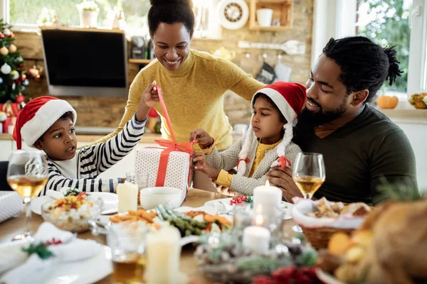 Happy Black Parents Kids Opening Christmas Presents While Having Family — ストック写真