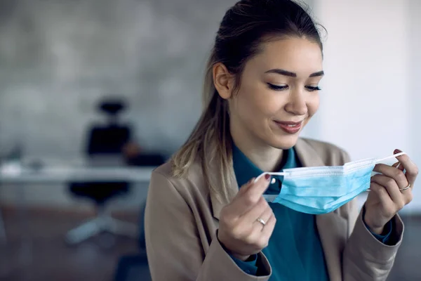 Smiling Female Entrepreneur Using Face Mask While Working Office Coronavirus — 스톡 사진