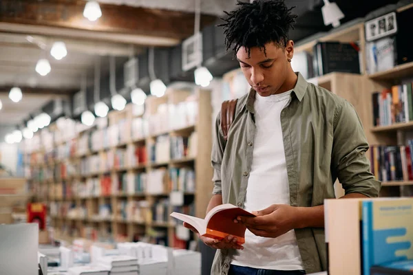 African American Student Reading Book While Standing Bookstore — Stockfoto